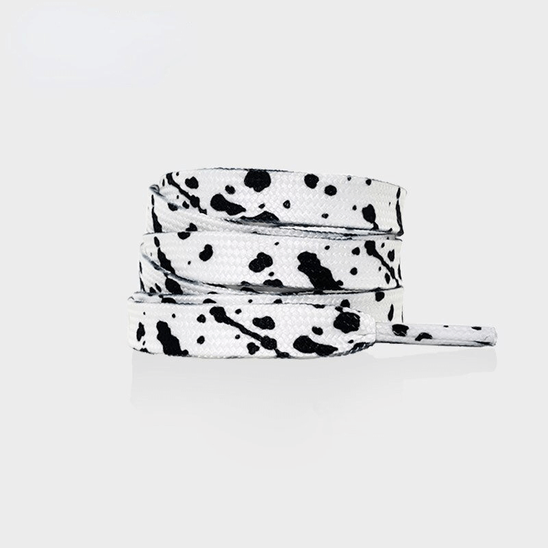 Flat black and white speckled shoelaces rolled neatly, perfect for sporty or casual shoes, made with durable polyester material for long-lasting use.