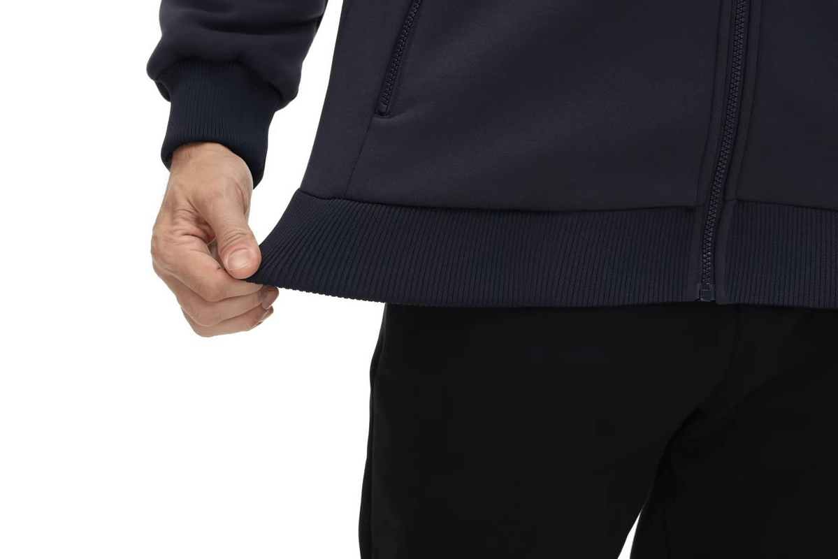 Close-up of navy blue fleece lining zipper Sherpa jacket with pockets, showcasing texture and design.