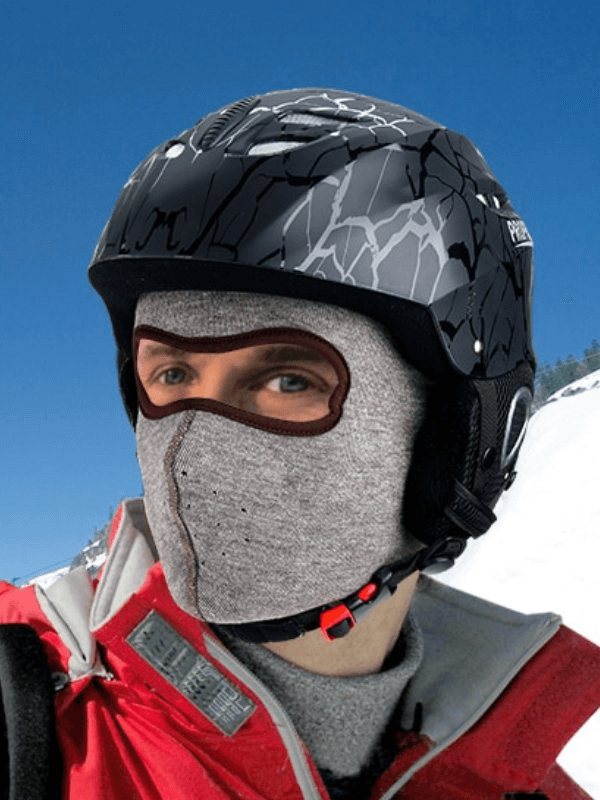 Person wearing fleece sports windproof face mask and helmet in snowy outdoor setting.