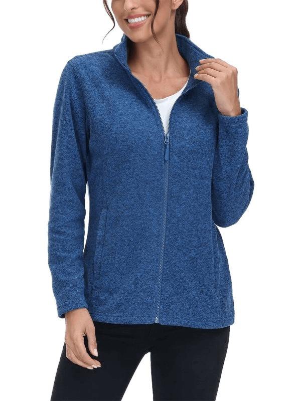 Woman wearing blue fleece sweatshirt with zipper, designed for running, featuring pockets and stand collar for added comfort and style.