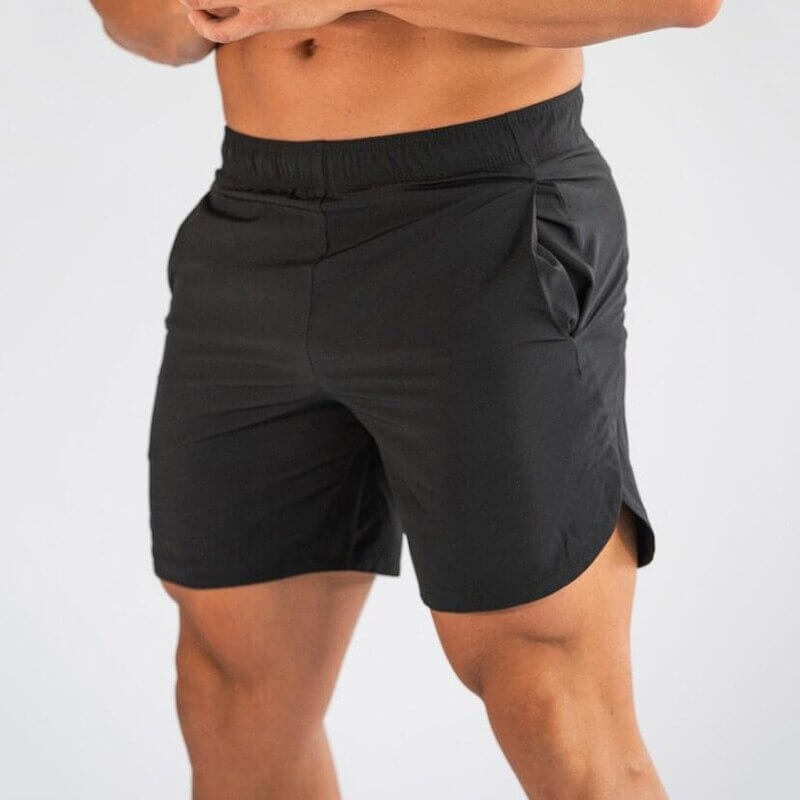 Man wearing black gym slim shorts for men, showing quick-dry fabric ideal for workouts like running or basketball. Style SF0409.