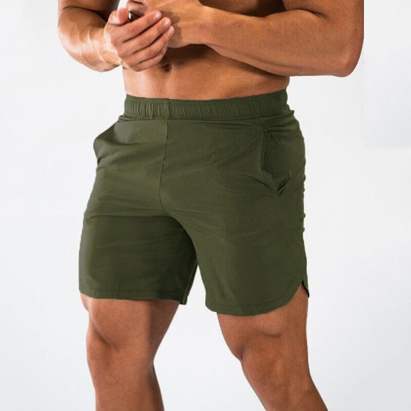 Male model wearing olive green gym slim shorts, ideal for running and intense workouts, featuring quick-dry fabric for ultimate comfort.