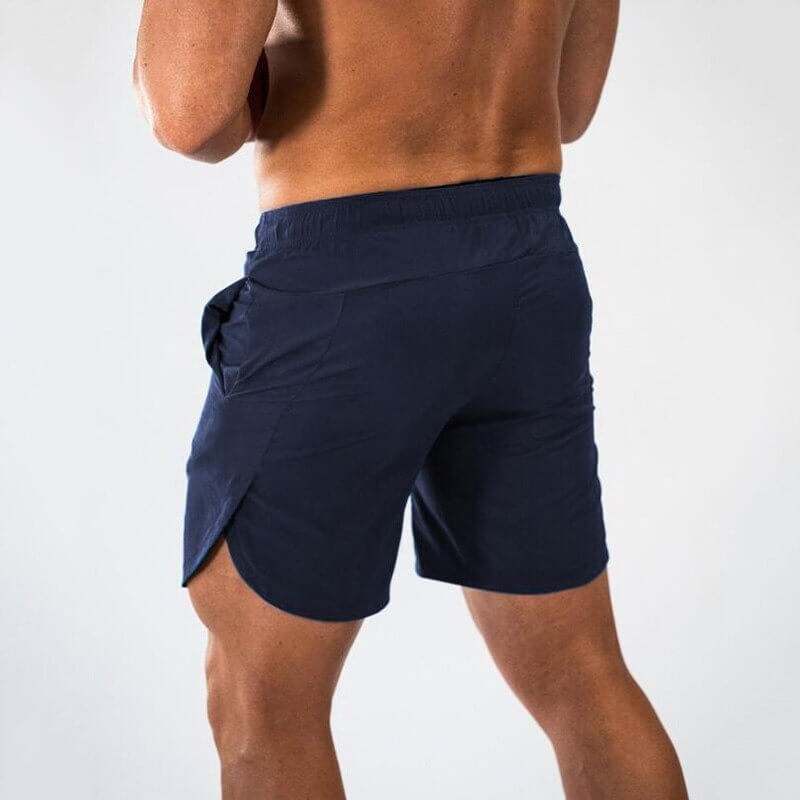 Back view of a man wearing navy blue gym slim shorts for running and workouts, featuring a quick-dry fabric for flexibility and comfort.