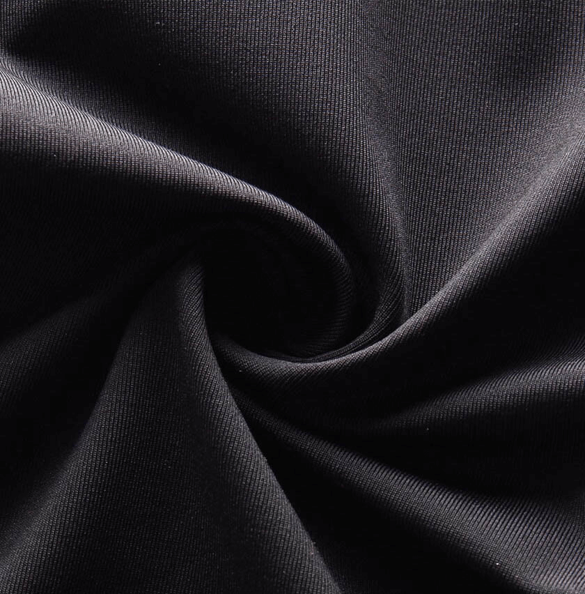 Close-up of black high-elastic compression leggings fabric texture, showcasing its stretchy and durable material for men’s sportswear.