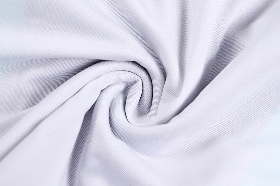 Close-up of soft white swimsuit fabric with a spiral twist texture, showcasing high elasticity and flexibility for beachwear.