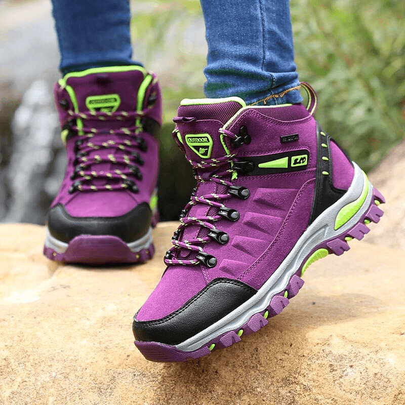 Women's purple mountaineering shoes with lace-up closure and durable soles, perfect for hiking and outdoor adventures.