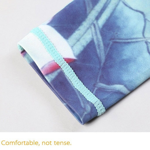 Close-up of floral print on high-waist sports leggings' hem, highlighting soft fabric and stitching.