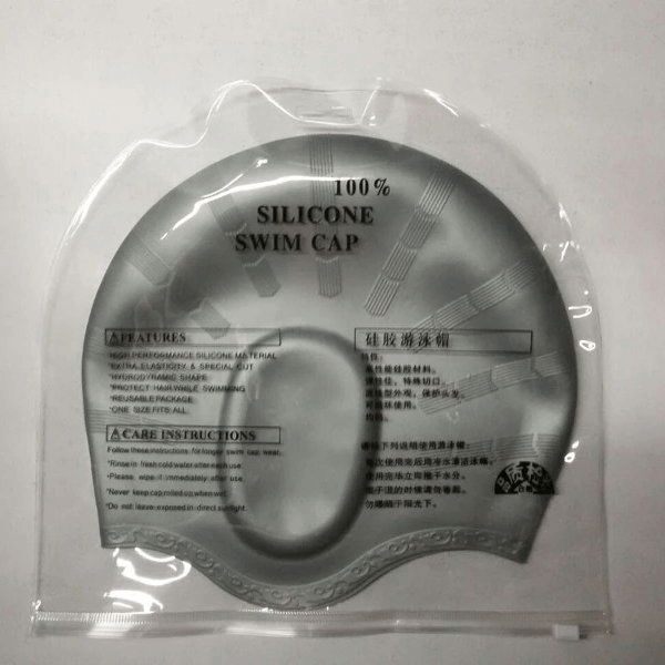 Highly elastic waterproof swimming cap in silicone, unisex design, shown in retail packaging. Ideal for sun, wind, and dust protection.