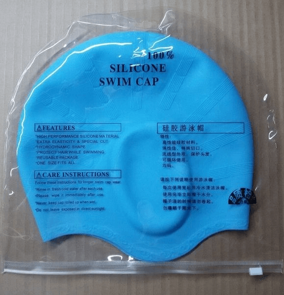 Blue silicone swim cap with high elasticity and waterproof features, displaying usage and care instructions on packaging.