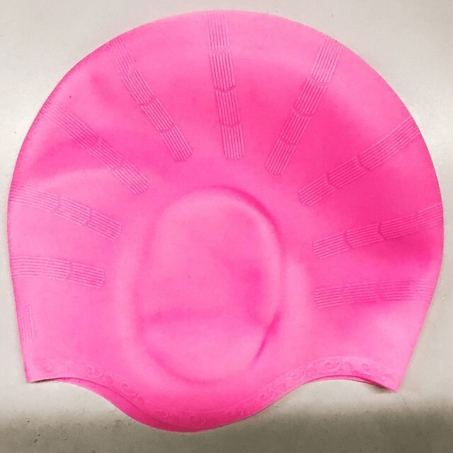 Bright pink silicone swimming cap offering high elasticity and waterproof protection, perfect for stress-free swimming.