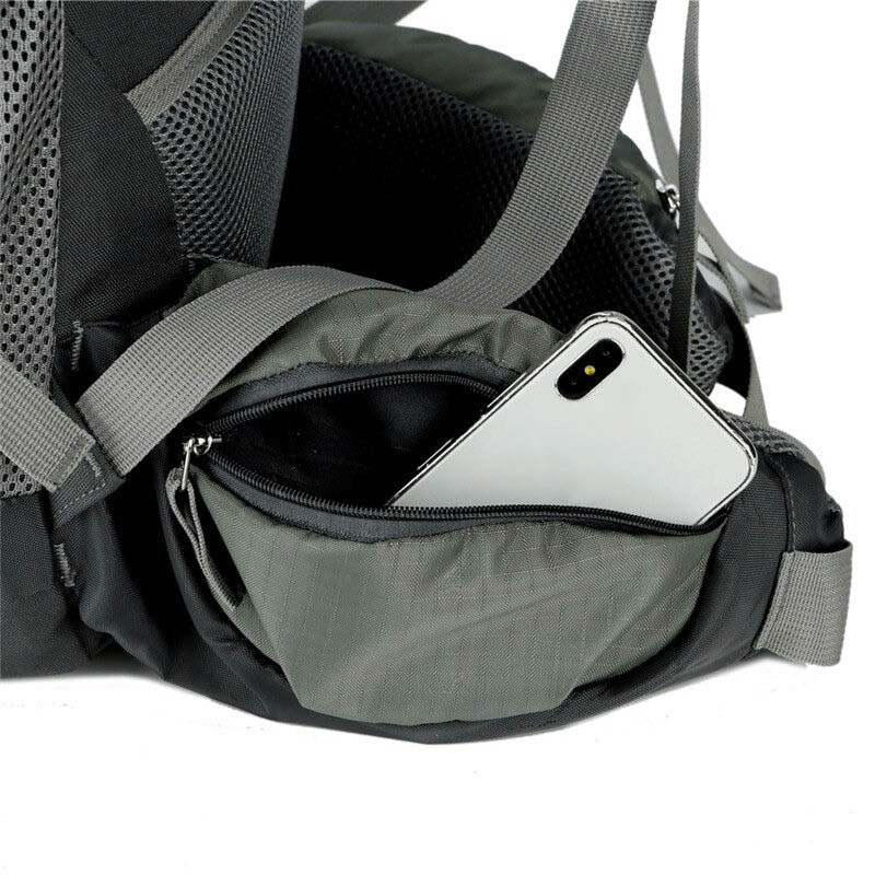 Spacious pocket of the hiking backpack with a phone inside, showcasing water-resistant material and adjustable straps.