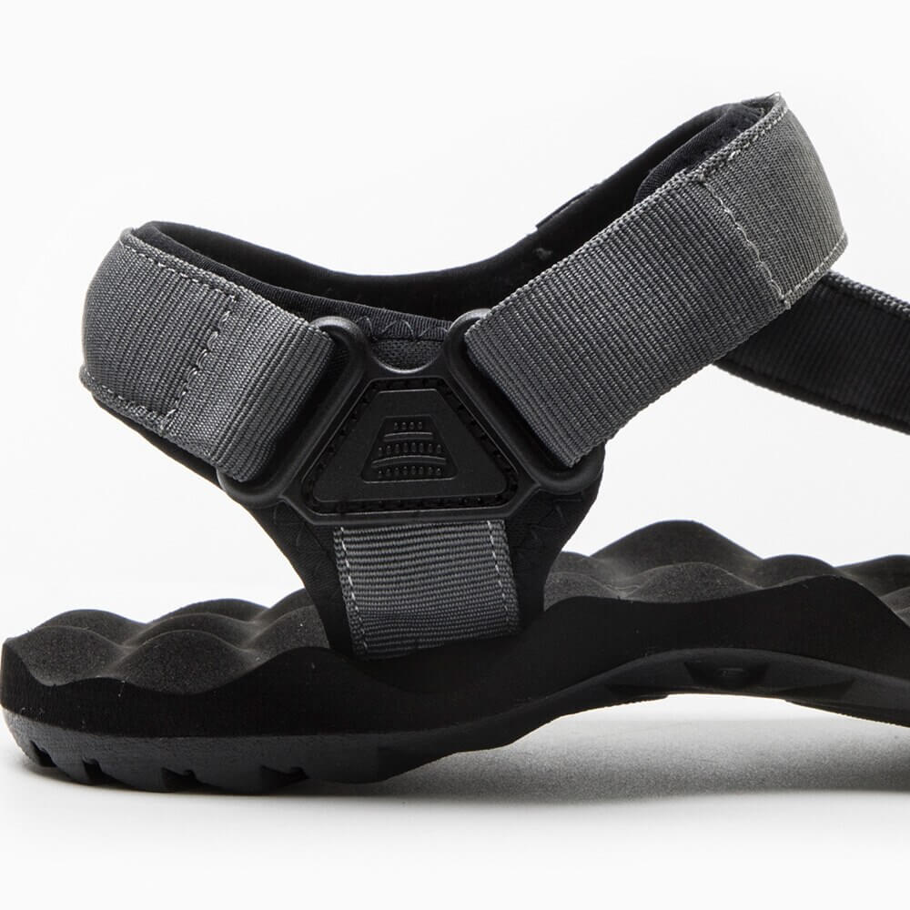 Close-up of men's hiking sandal in canvas with hook and loop closure, featuring durable construction and soft EVA padding.