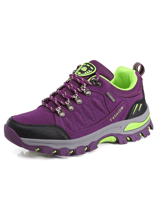 Purple hiking shoes for women with green accents, featuring durable rubber outsole and secure lace-up closure, ideal for mountaineering.
