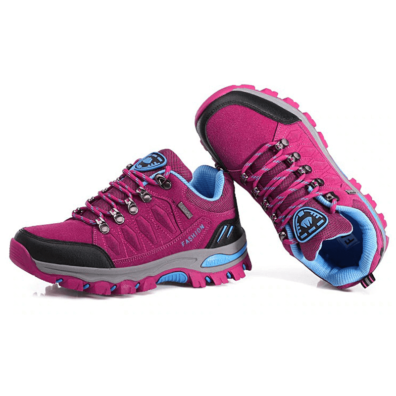 Vibrant purple hiking shoes for women with durable cotton fabric, rubber outsoles, and secure lace-up closure for mountain adventures.