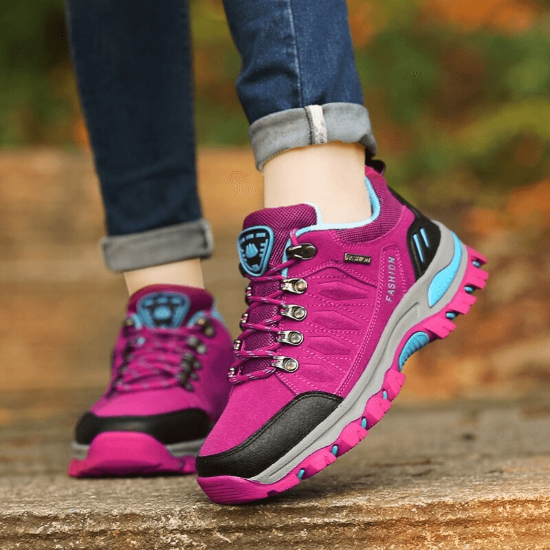 Women's purple hiking shoes with sturdy outsole, ideal for mountain adventures and outdoor sports, featuring a lace-up design.