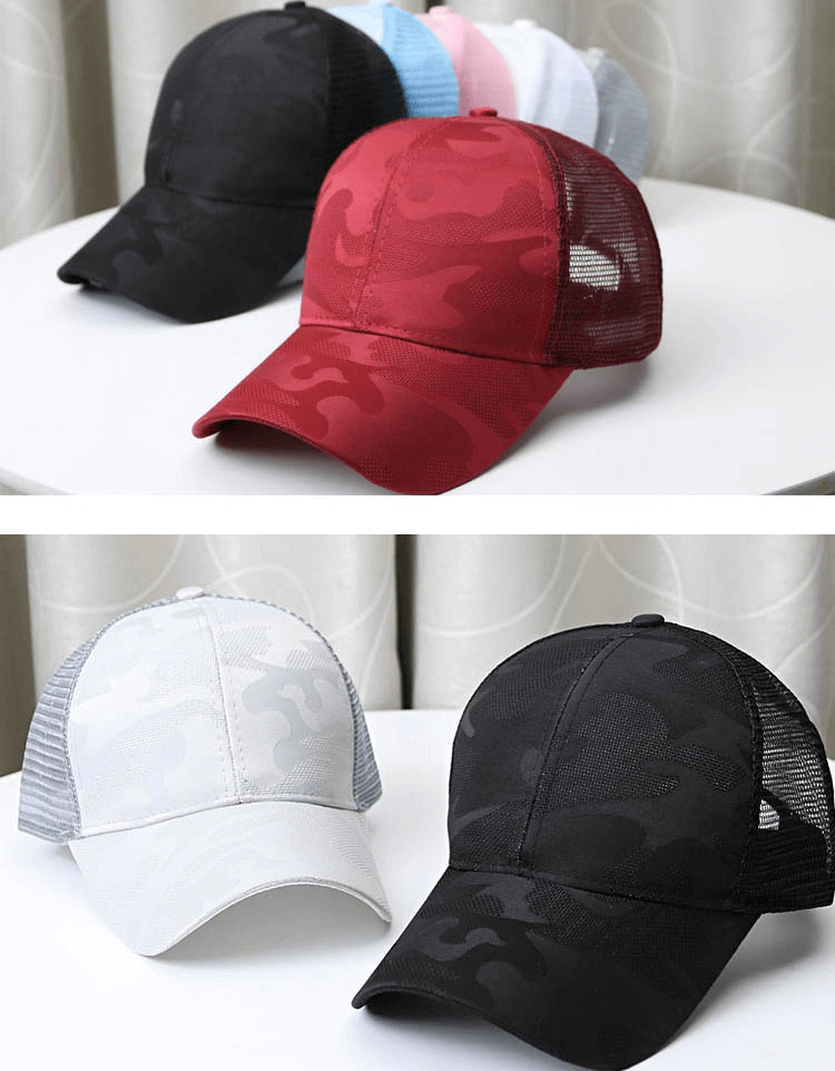 Colorful hollow-out ponytail baseball caps on a table, featuring breathable mesh design and adjustable snapback for outdoor sports.