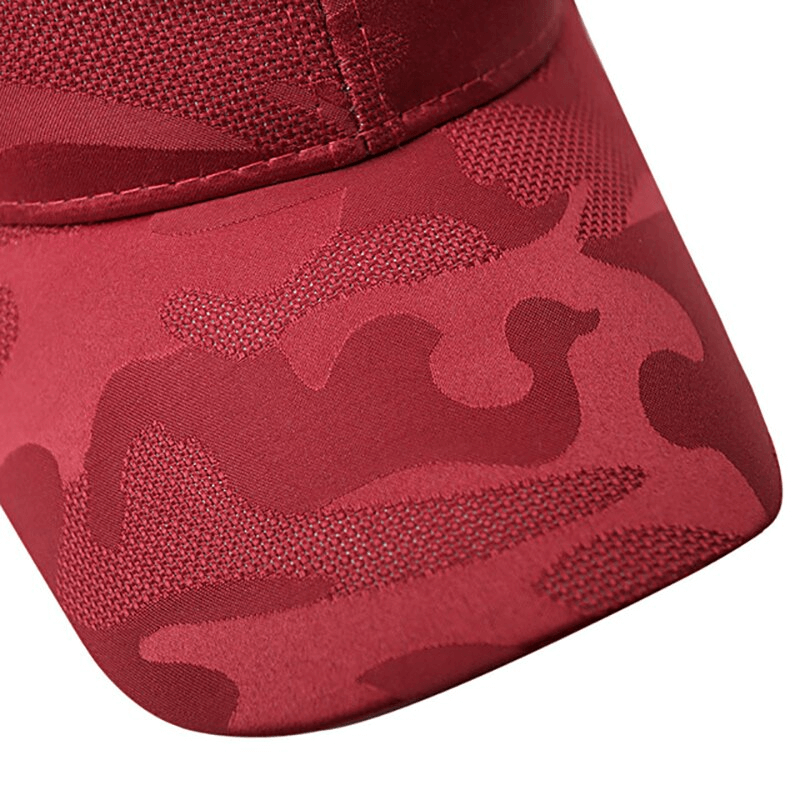 Close-up of red camo-patterned baseball cap with breathable cotton fabric and stylish design for outdoor sports.