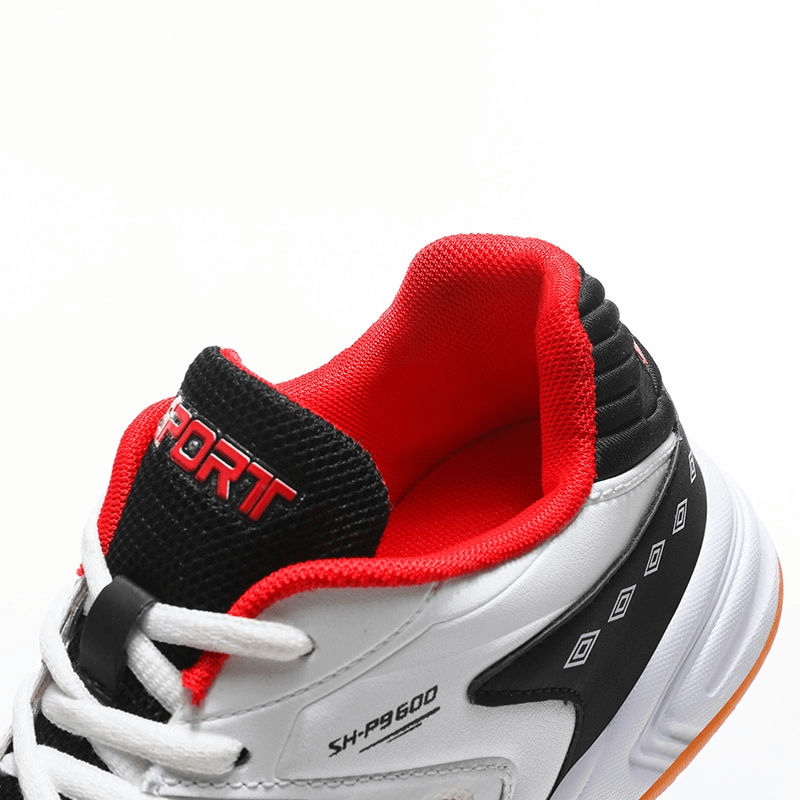 Close-up of black and red lace-up breathable tennis shoe with flexible design.