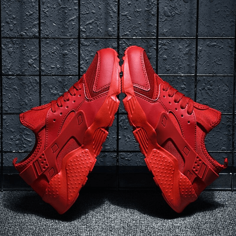 Red lace-up mesh elastic running shoes with breathable design and superior grip, ideal for marathoners seeking performance and comfort.
