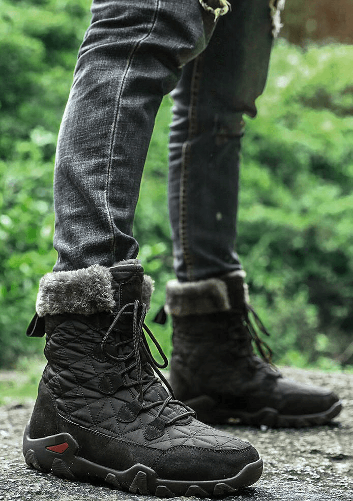 Person wearing lace-up waterproof non-slip mid-calf snow boots with fur, perfect for winter comfort and warmth.