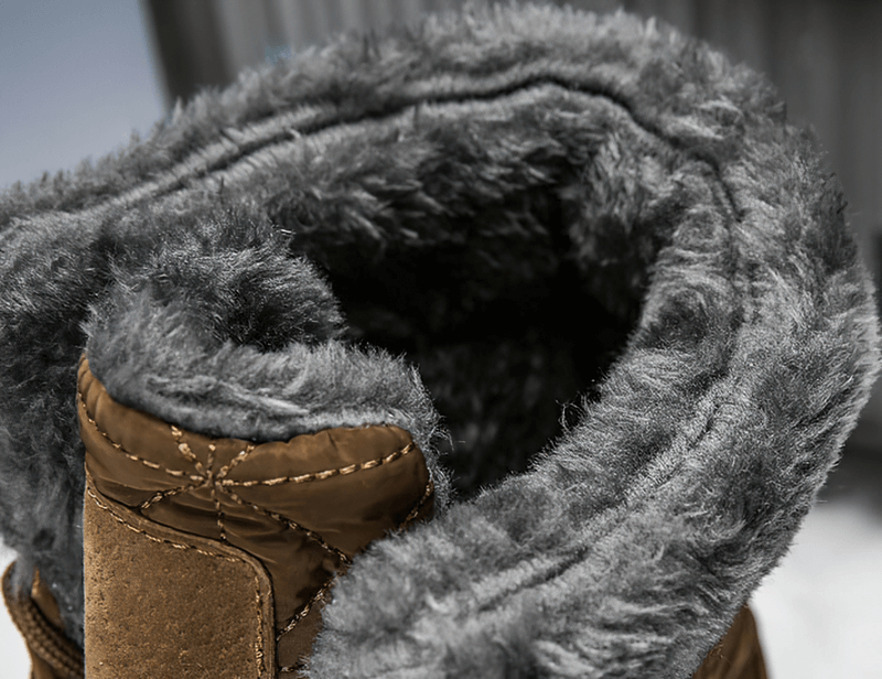 Close-up of plush fur lining inside lace-up waterproof mid-calf snow boots for warmth and comfort.