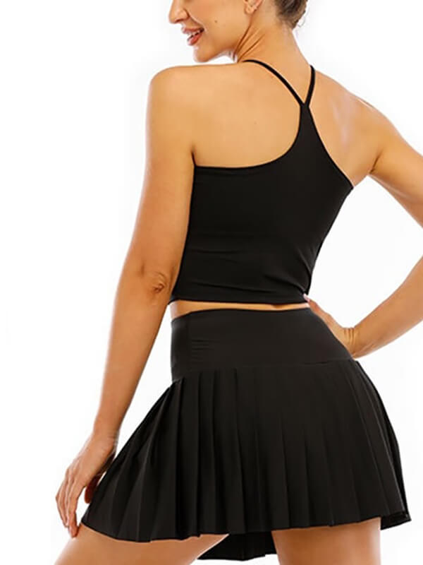 Woman wearing black high waist pleated tennis skirt, perfect for sports like yoga, running, and training.