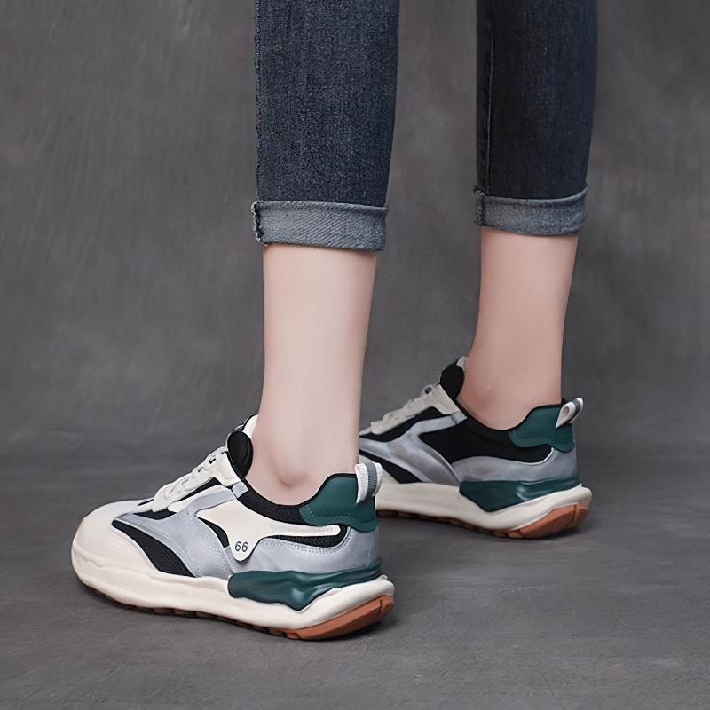 Woman wearing ladies sports thick sole vulcanized shoes with jeans, showcasing stylish stitching and comfortable thick soles.