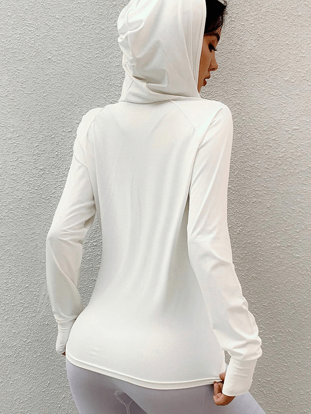 Woman in white thin sports hoodie with thumb holes, showcasing lightweight and breathable activewear for running.