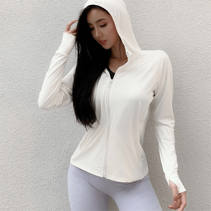 Woman wearing white thin sports hoodie with thumb holes, perfect for running and yoga, featuring quick-dry and anti-wrinkle fabric.
