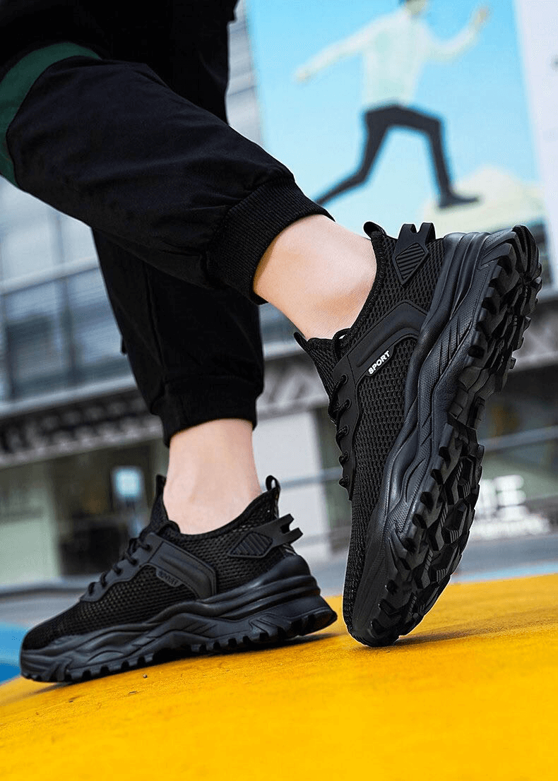 Person wearing black lightweight running shoes with cushioning and breathable upper, perfect for male athletes. Features EVA insole.