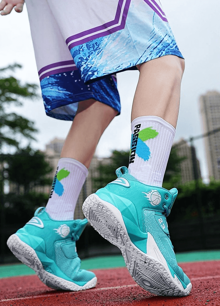 Person wearing teal and white sports sneakers on a red and green athletic track, showcasing breathable and cushioned design.