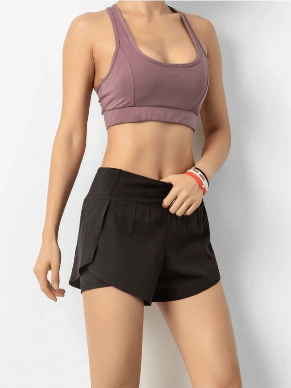 Woman wearing lightweight elastic quick dry shorts for sports, featuring a comfortable fit and breathable material.