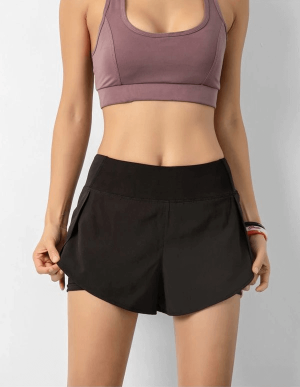 Woman wearing lightweight elastic quick dry shorts, perfect sportswear for active comfort and freedom of movement.