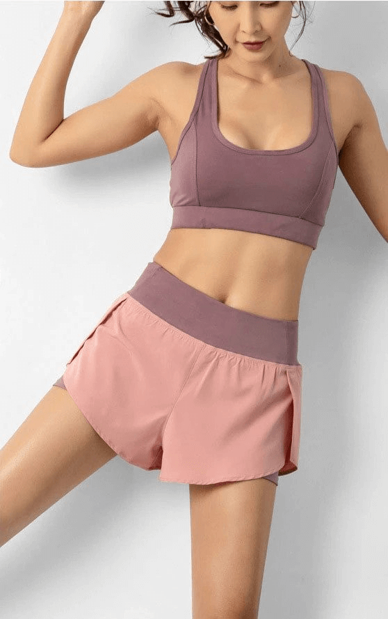 Woman wearing lightweight elastic quick dry shorts SF0215 for women’s sportswear, showcasing comfort and mobility.