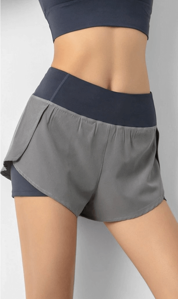 Stylish grey lightweight elastic quick dry shorts for women, featuring a breathable fabric and comfortable fit, perfect for sportswear.