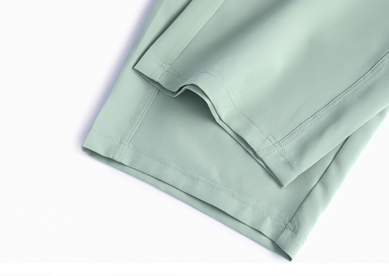 Close-up of lightweight mint green workout sweatpants fabric, showcasing breathable and quick-dry features for optimal fitness comfort.