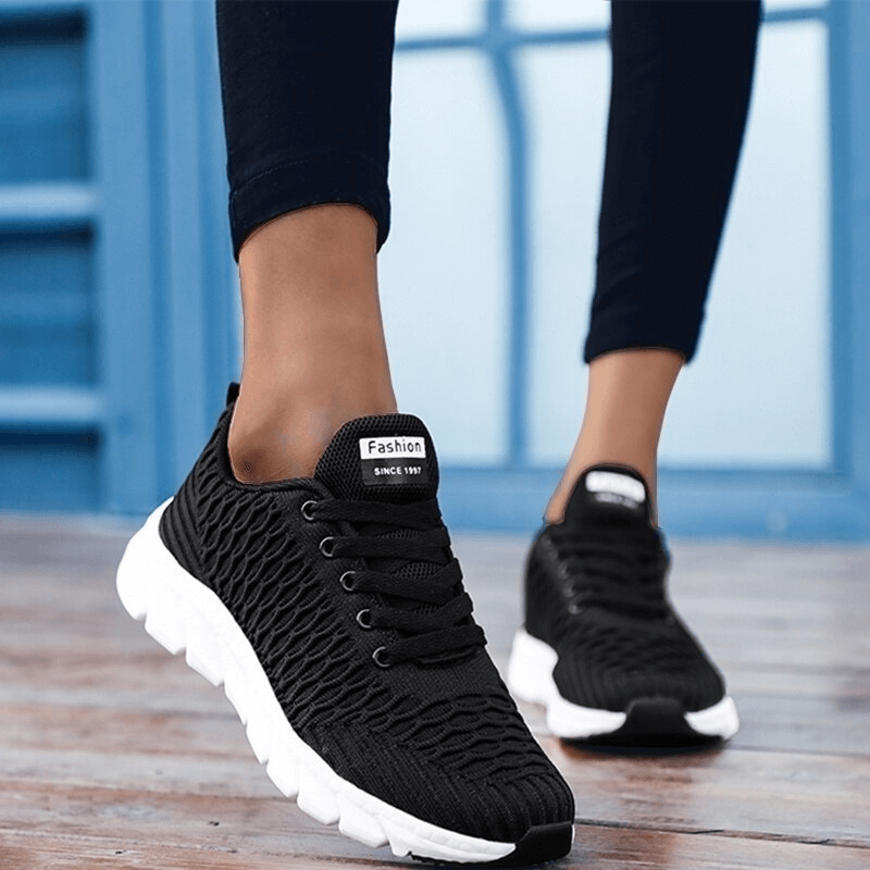 Black mesh women's training sneakers with EVA outsole, lace-up closure, and comfortable low-height breathable design.