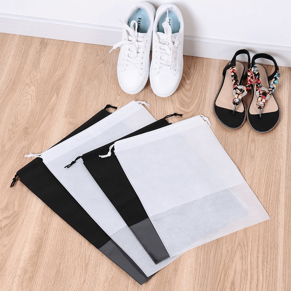 Unisex lightweight quick-dry shoe bags in black and white for sports shoes, made from durable waterproof non-woven fabric.