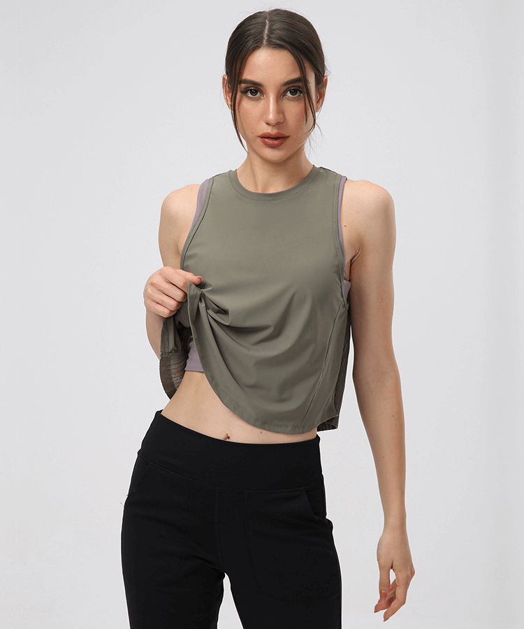 Model wearing a lightweight quick dry women's sleeveless t-shirt with mesh back, ideal for yoga and running, in a stylish design.