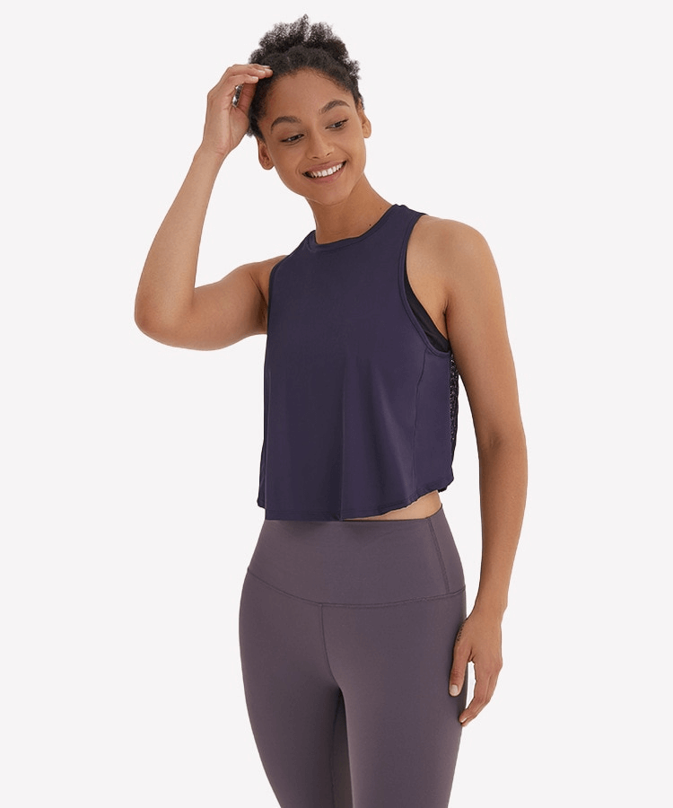 Woman wearing a lightweight quick-dry sleeveless t-shirt with mesh back, ideal for yoga and exercise, in a breathable fabric.