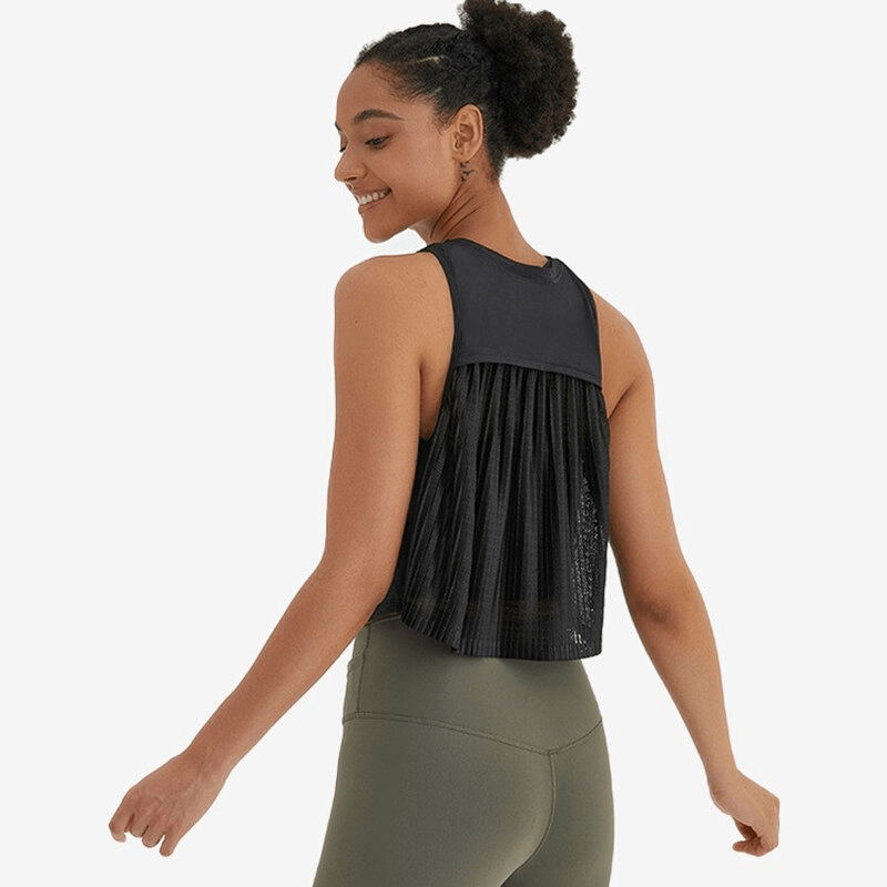 Woman wearing a lightweight quick dry sleeveless t-shirt with mesh back, perfect for running and yoga.