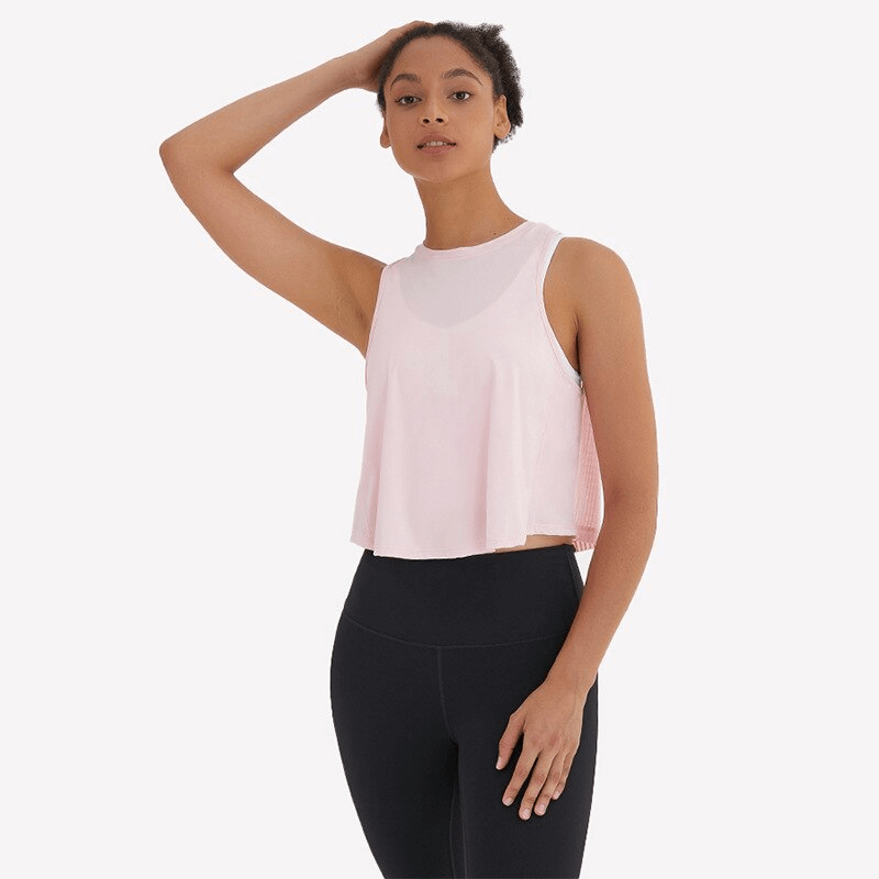 Woman wearing a pink lightweight quick-dry sleeveless t-shirt with mesh back, ideal for workouts and yoga.