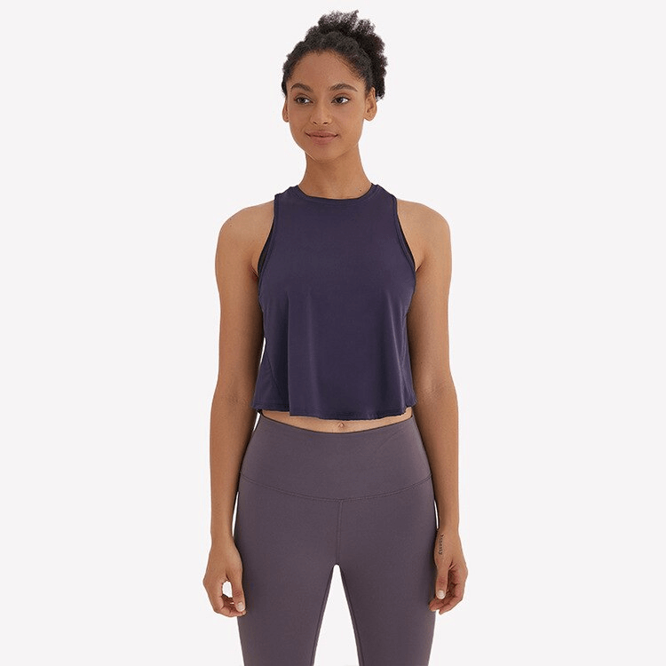 Woman wearing a navy sleeveless quick-dry t-shirt with mesh back, designed for activewear, exercise, and yoga, product code SF1055.