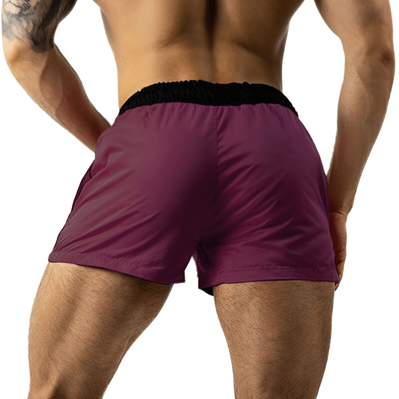 Back view of man wearing lightweight quick-drying sports fitness shorts in maroon, perfect for active lifestyle and running.