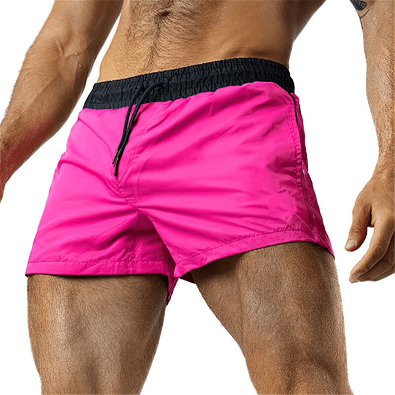 Man wearing pink lightweight quick-drying sports fitness shorts SF1150, perfect for running and active lifestyles.