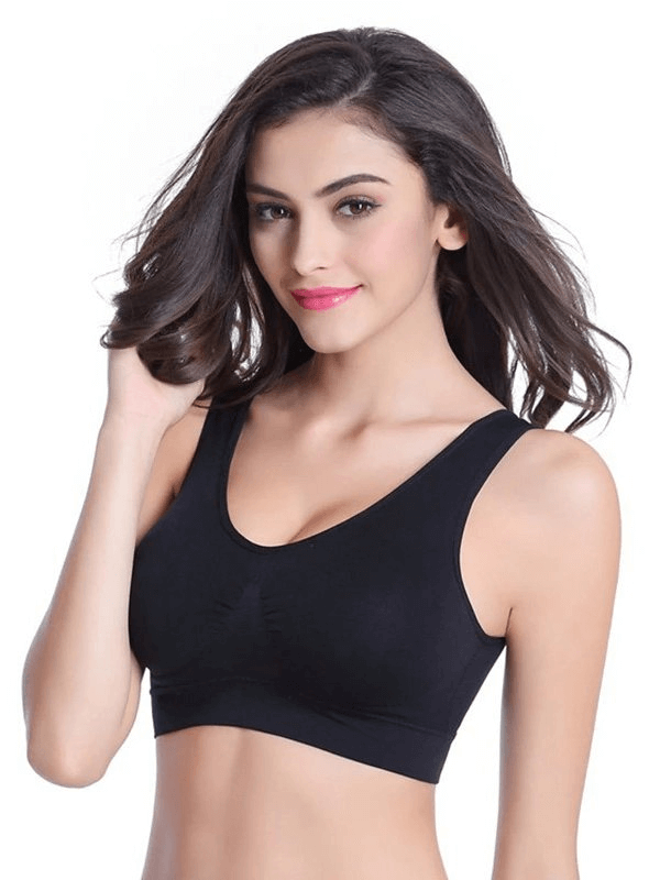Model wearing black lightweight solid color women's sports bra for fitness, featuring wire-free support and seamless design.