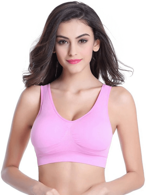 Lightweight solid color pink sports bra for women, featuring seamless design and padded support. Ideal for fitness activities.
