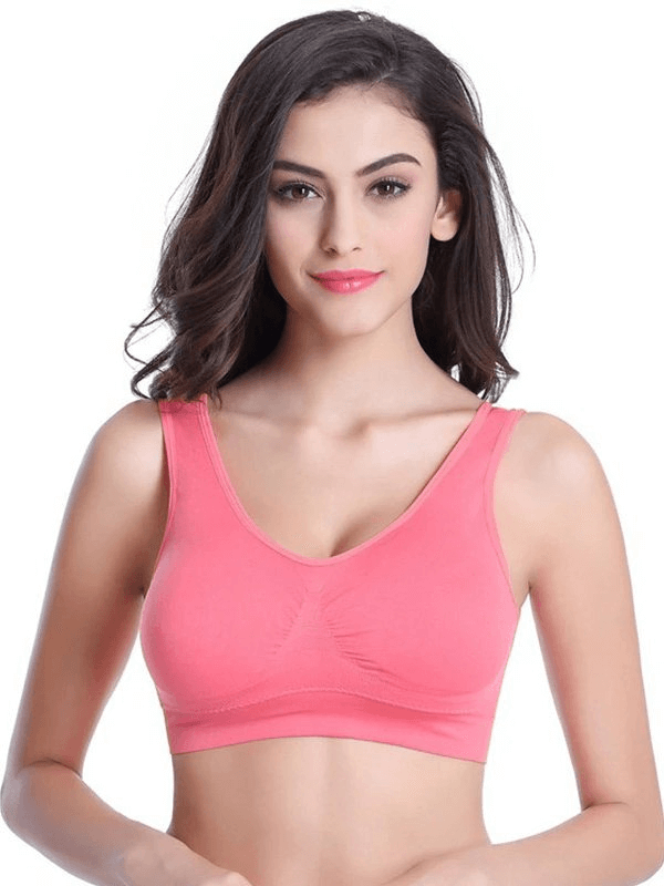 Woman wearing a pink lightweight sports bra for fitness, crafted from breathable fabric, offering seamless comfort and push-up support.