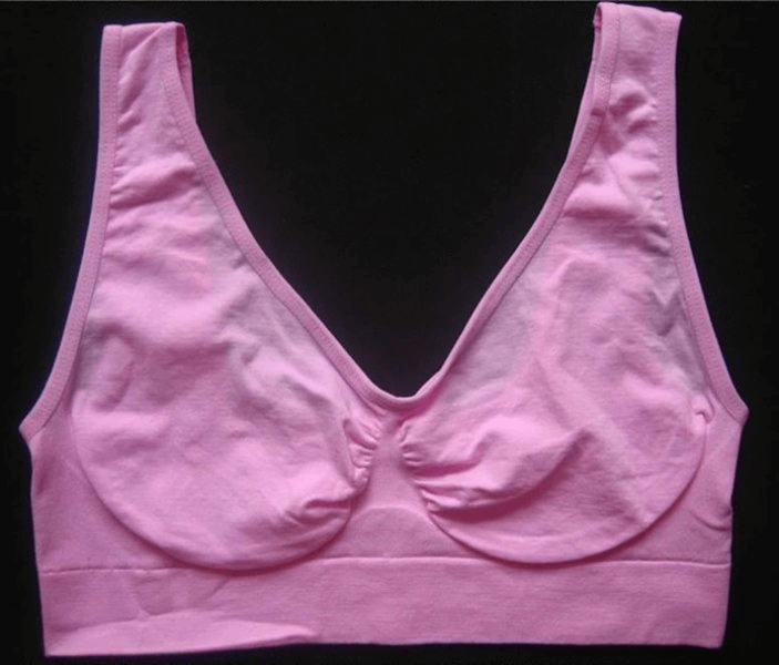 Lightweight pink women's sports bra, seamless and wire-free, perfect for fitness and everyday wear, with padded support.