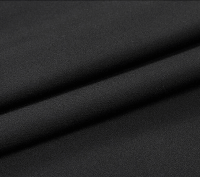 Close-up of black polyester and spandex blend fabric used in lightweight sports compression shirts for men.